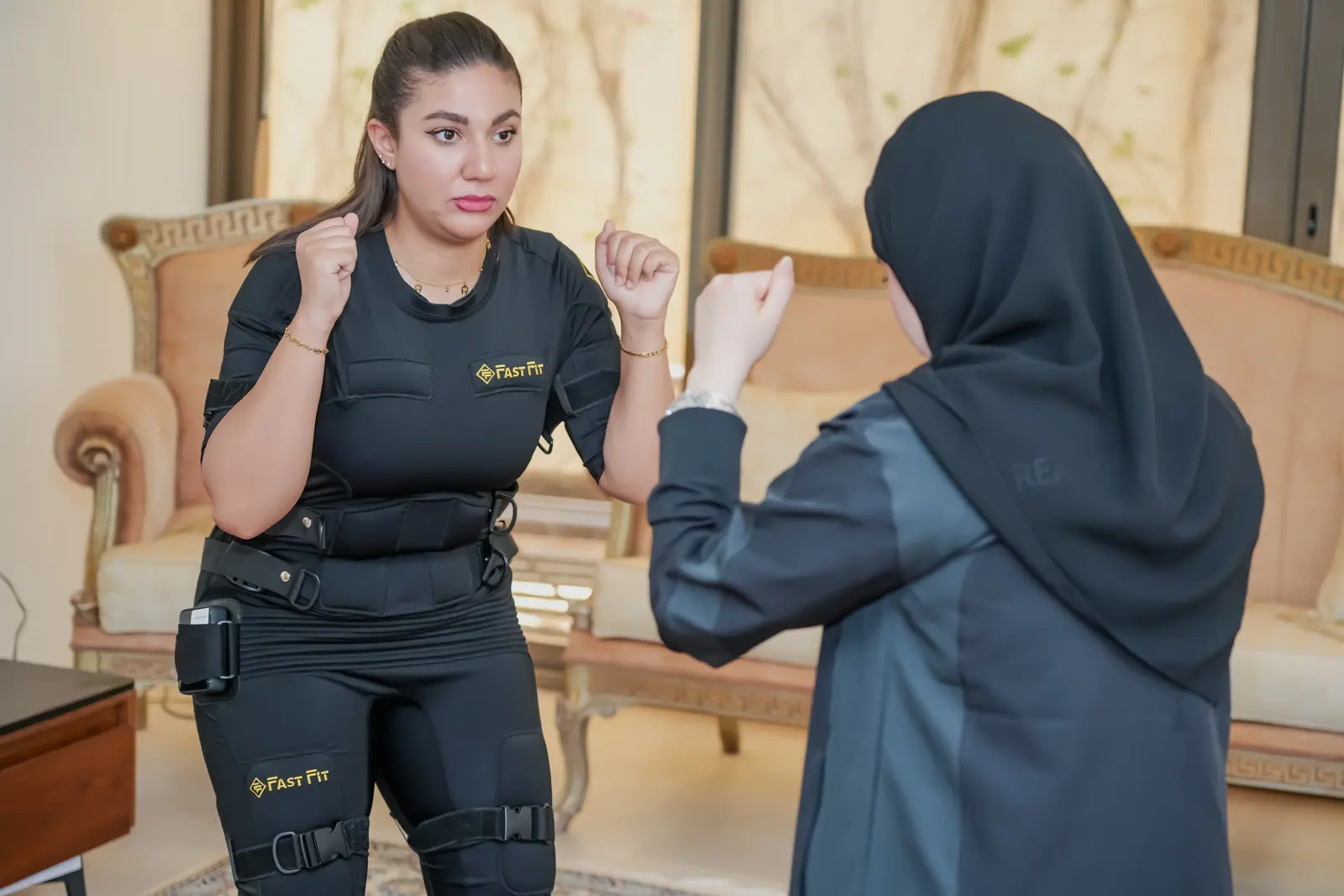Female trainer and client during a home EMS session