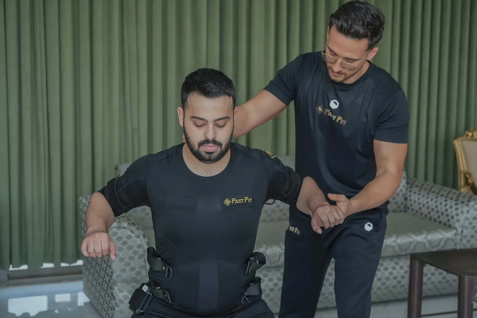 Male trainer and client during a home EMS session